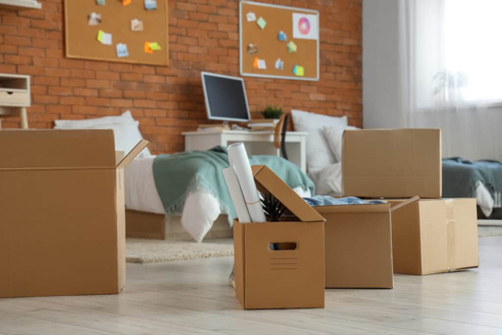 college dorm room with moving boxes.