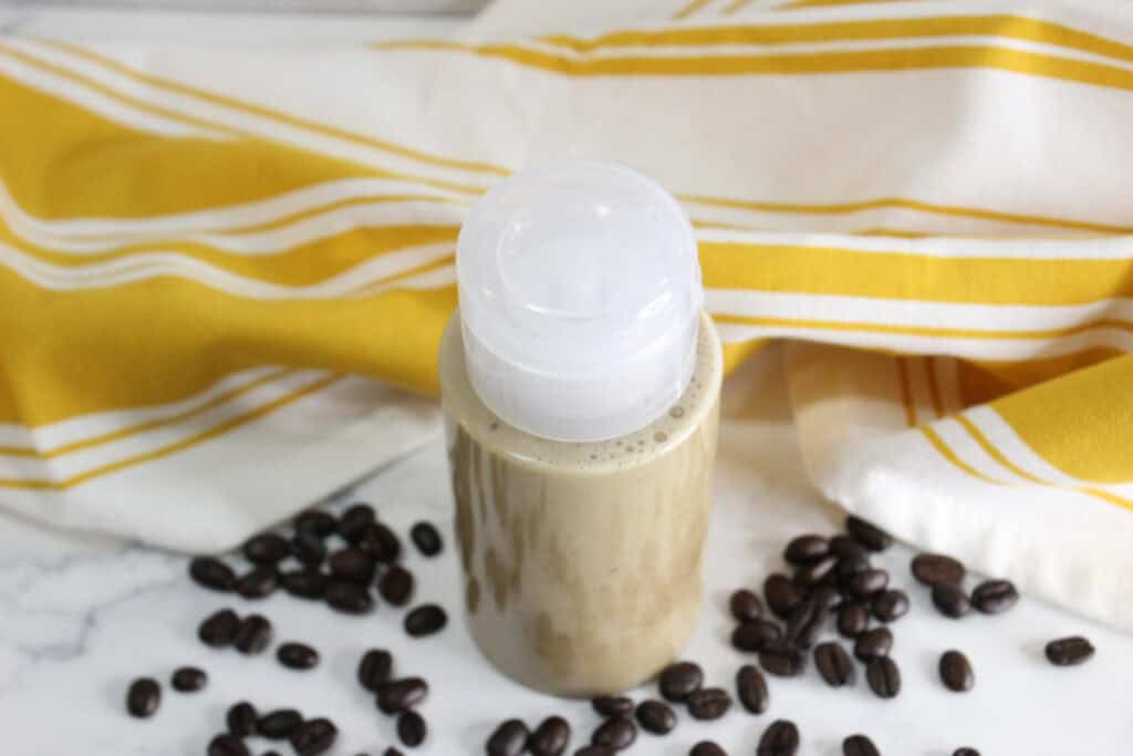 Coffee face wash mixture in container, top view.